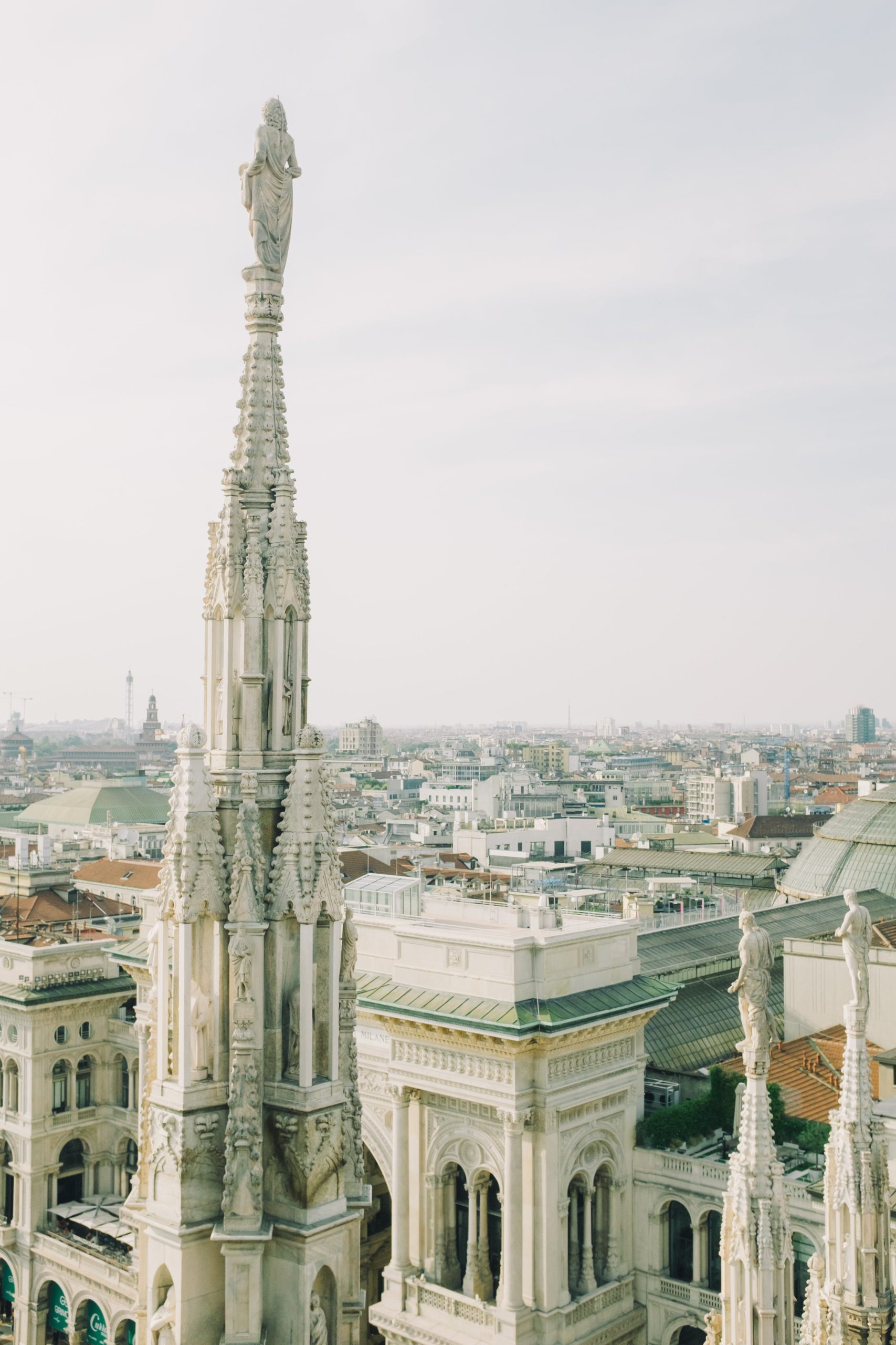 A stunning aerial view of the Duomo di Milano, showcasing its intricate architecture and the sprawling cityscape of Milan, Italy.